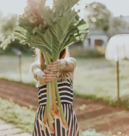 woman holding green vegetable