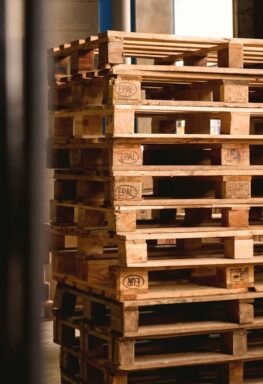 selective focus photography of piled brown wooden pallets